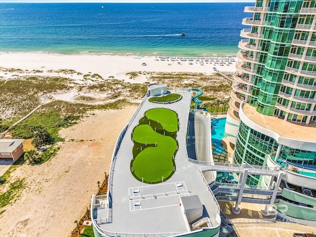 aerial view with a water view and a beach view