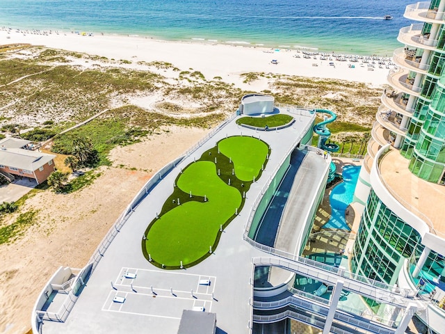 birds eye view of property featuring a beach view and a water view