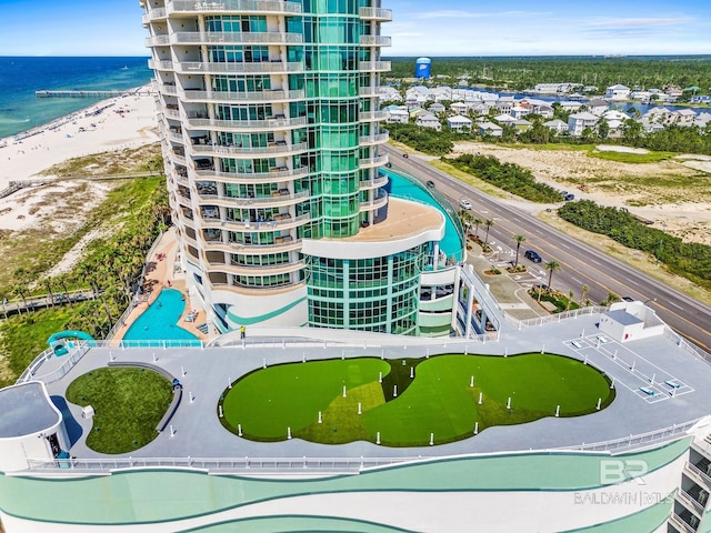 birds eye view of property with a view of the beach and a water view