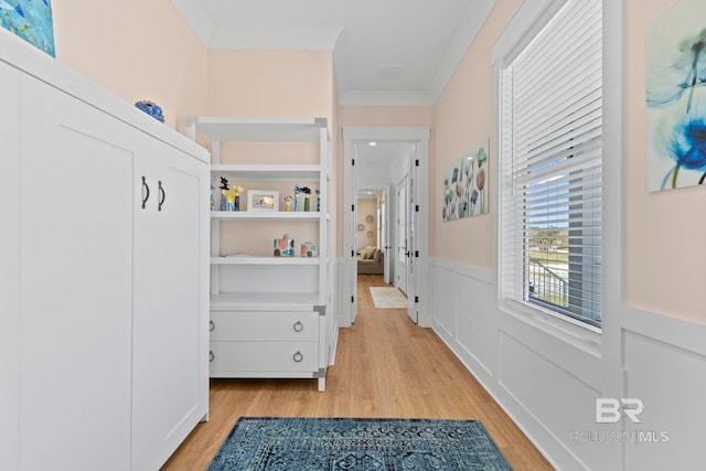 4029 Landfall Dr, Pensacola, FL 32507 - corridor featuring a wainscoted wall, ornamental molding, a decorative wall, and light wood-type flooring