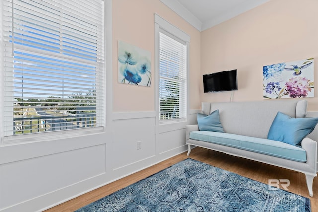 4029 Landfall Dr, Pensacola, FL 32507 - living area with a decorative wall, wood finished floors, crown molding, and wainscoting
