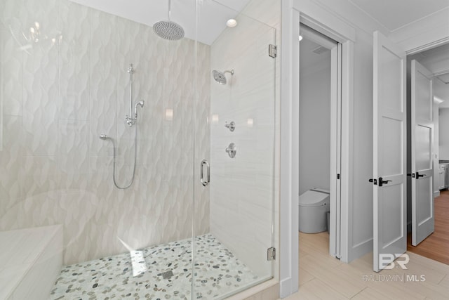 4029 Landfall Dr, Pensacola, FL 32507 - full bathroom featuring a stall shower, toilet, and wood finished floors
