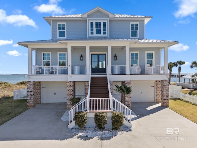 4029 Landfall Dr, Pensacola, FL 32507 - coastal inspired home with metal roof, covered porch, and a standing seam roof
