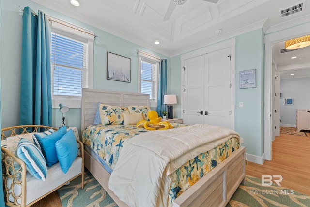 4029 Landfall Dr, Pensacola, FL 32507 - bedroom with crown molding, baseboards, light wood finished floors, visible vents, and a closet