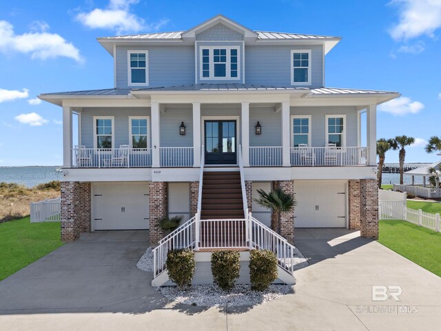 4029 Landfall Dr, Pensacola, FL 32507 - raised beach house featuring covered porch, a standing seam roof, and metal roof