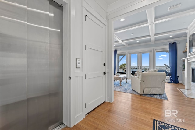 4029 Landfall Dr, Pensacola, FL 32507 - corridor with coffered ceiling, beam ceiling, elevator, light wood-style floors, and recessed lighting