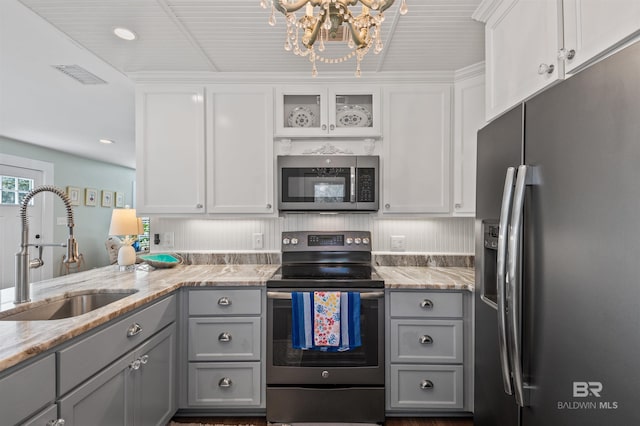 kitchen with visible vents, appliances with stainless steel finishes, gray cabinetry, and a sink