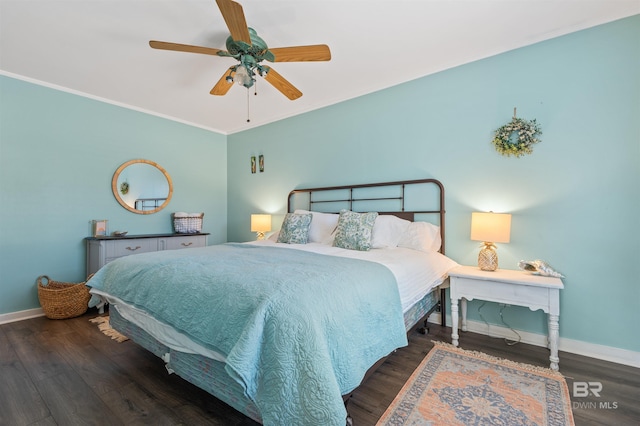 bedroom featuring wood finished floors, baseboards, and ornamental molding