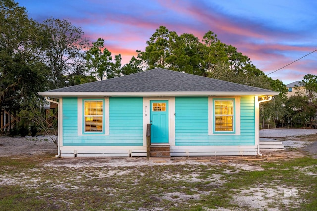 bungalow-style house featuring entry steps and roof with shingles