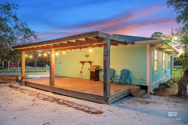 back of property at dusk featuring volleyball court