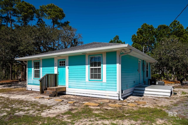 bungalow-style house with central air condition unit