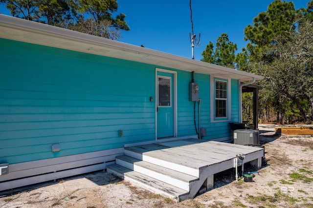 doorway to property featuring central air condition unit