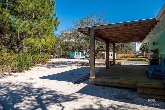 view of patio / terrace with an outbuilding and a grill