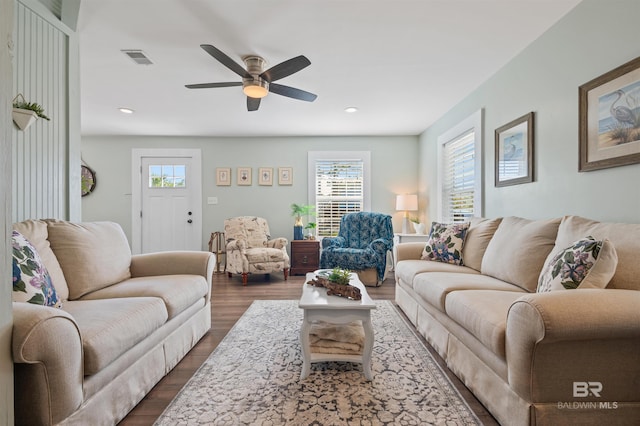 living room with recessed lighting, visible vents, a ceiling fan, and dark wood-style flooring