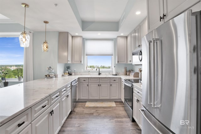 608 Lost Key Dr Unit 705C, Pensacola, FL 32507 - kitchen featuring appliances with stainless steel finishes, a sink, plenty of natural light, wood finished floors, and recessed lighting