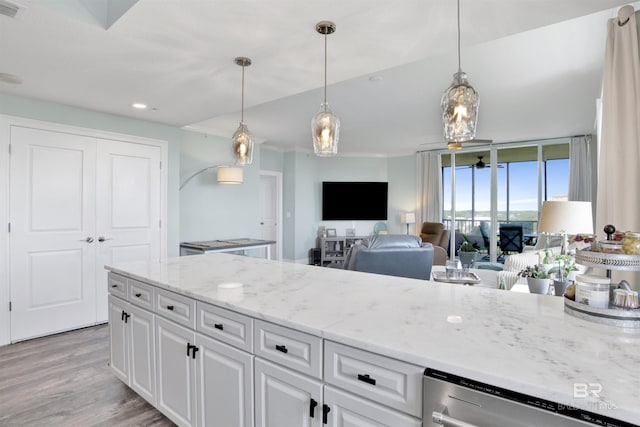 608 Lost Key Dr Unit 705C, Pensacola, FL 32507 - kitchen with light wood-style flooring, stainless steel dishwasher, white cabinets, light stone counters, and pendant lighting