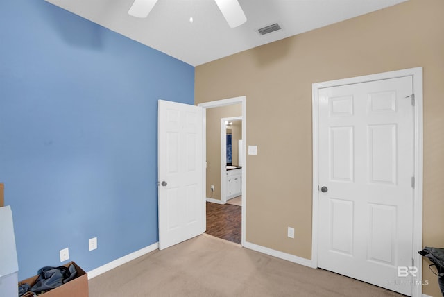 unfurnished bedroom featuring light carpet and ceiling fan