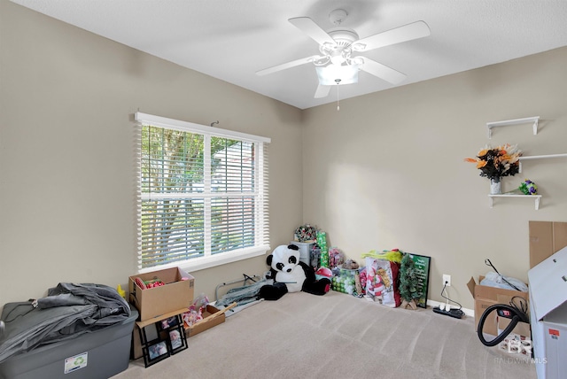 interior space featuring ceiling fan and light colored carpet