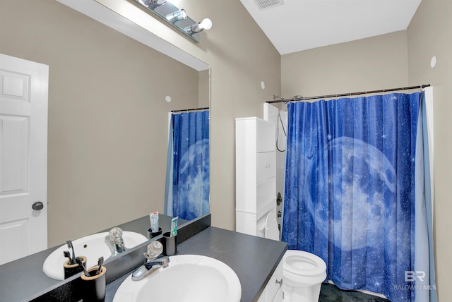 bathroom with curtained shower, vanity, and toilet