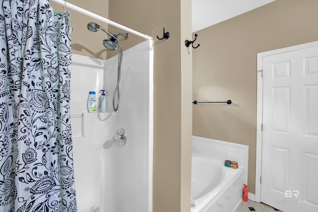 bathroom featuring tile patterned floors and separate shower and tub