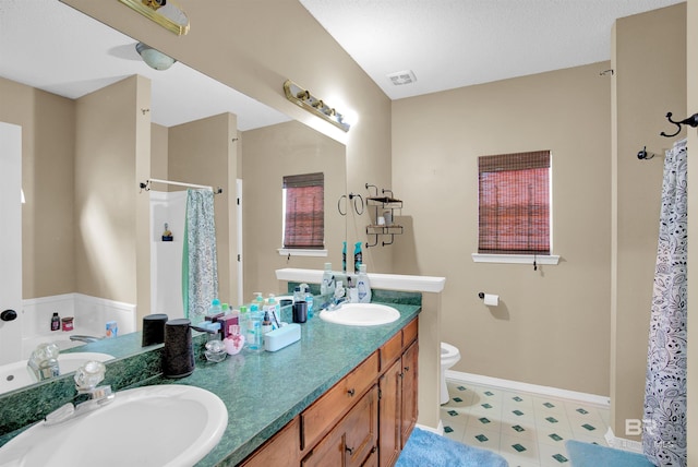 full bathroom featuring shower with separate bathtub, vanity, and toilet