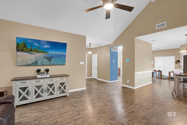 living room featuring high vaulted ceiling, ceiling fan, and dark wood-type flooring