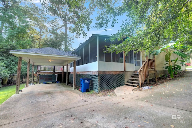 view of front of property featuring a carport and a sunroom