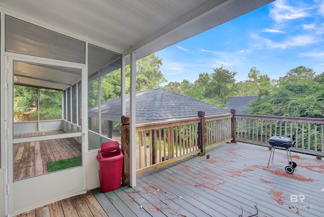 wooden deck with a sunroom