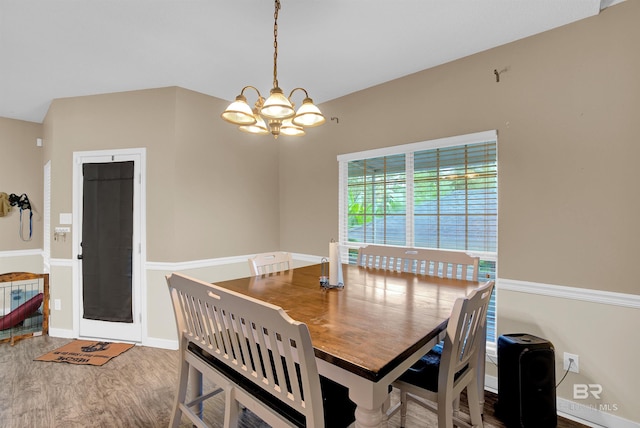 dining area featuring a notable chandelier and hardwood / wood-style floors