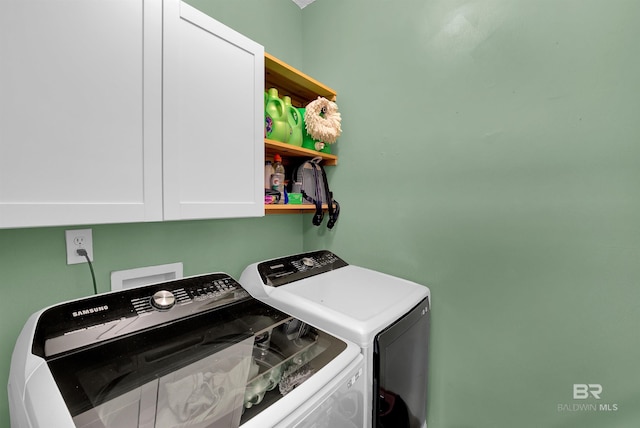 laundry room with cabinets and washing machine and dryer