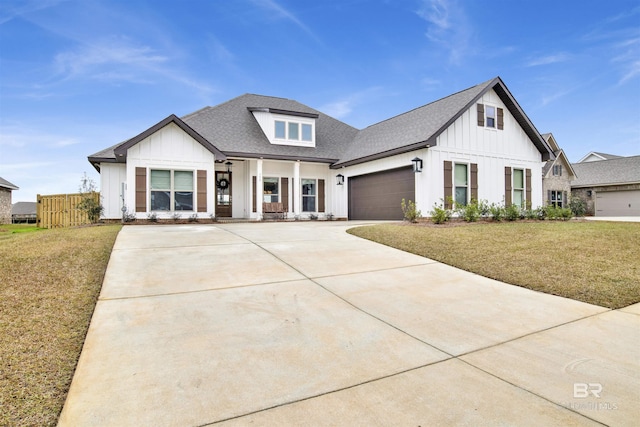 modern farmhouse style home featuring a garage and a front lawn