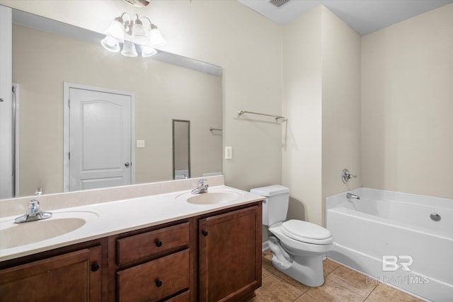 bathroom featuring vanity, a bath, tile patterned flooring, toilet, and a chandelier