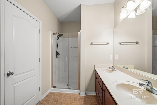 bathroom with tile patterned flooring, vanity, and walk in shower