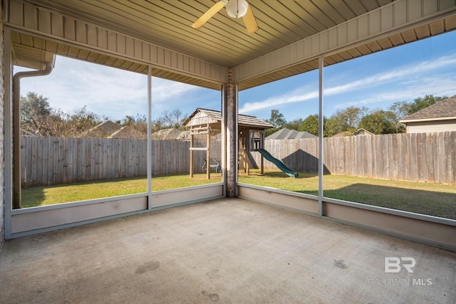 unfurnished sunroom featuring ceiling fan and a wealth of natural light