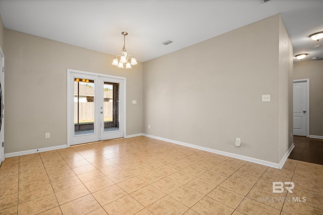 tiled empty room with a notable chandelier