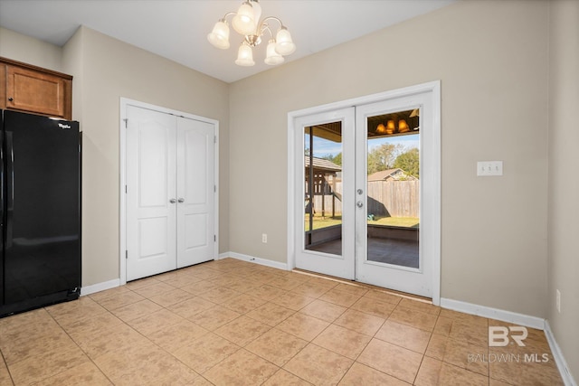 interior space with light tile patterned floors, french doors, and a chandelier