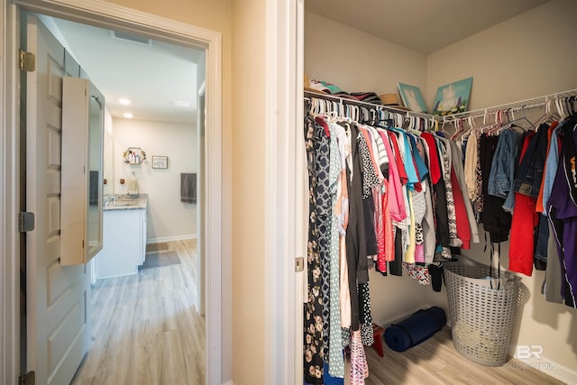 walk in closet featuring light wood-type flooring and visible vents