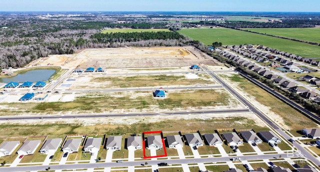 birds eye view of property with a water view and a residential view