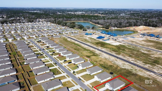 birds eye view of property with a water view and a residential view