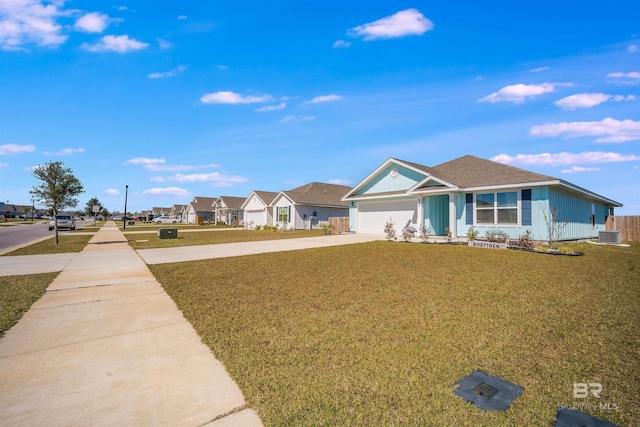 ranch-style home featuring central AC unit, an attached garage, driveway, a residential view, and a front yard