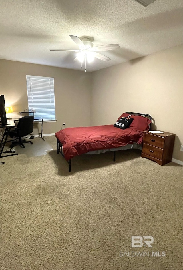 bedroom featuring a textured ceiling, carpet, and ceiling fan