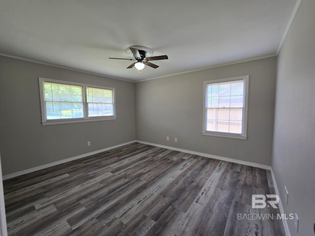 114 Spruce Ave, Brewton, AL 36426 - spare room featuring healthy amount of natural light, ornamental molding, dark wood-type flooring, and baseboards