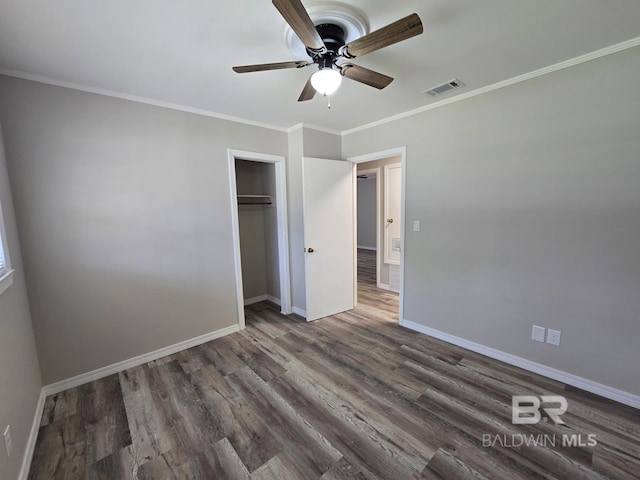 114 Spruce Ave, Brewton, AL 36426 - unfurnished bedroom featuring wood finished floors, baseboards, ornamental molding, and a closet