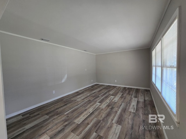 114 Spruce Ave, Brewton, AL 36426 - spare room with dark wood finished floors, baseboards, and ornamental molding