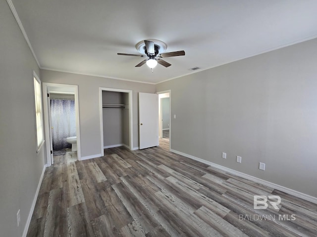 114 Spruce Ave, Brewton, AL 36426 - unfurnished bedroom with wood finished floors, ornamental molding, baseboards, a closet, and a ceiling fan