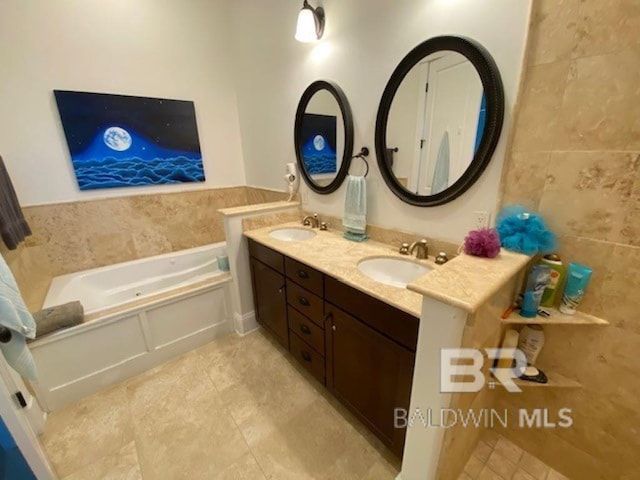 bathroom featuring a tub to relax in, tile walls, and vanity