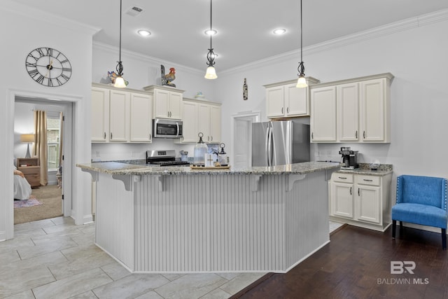 kitchen with pendant lighting, light stone countertops, light hardwood / wood-style floors, a kitchen island, and stainless steel appliances