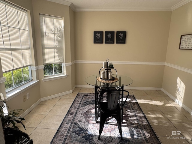 dining room featuring light tile patterned floors, baseboards, crown molding, and visible vents