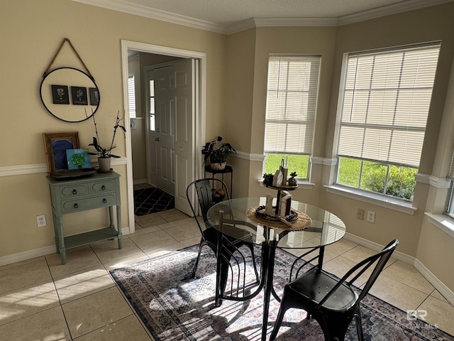 dining space with baseboards, ornamental molding, and light tile patterned floors
