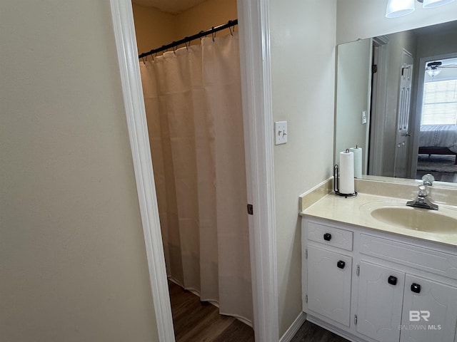 bathroom with vanity and wood finished floors